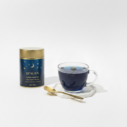 D'Aura lunar calm tea canister with a glass of tea on a white background