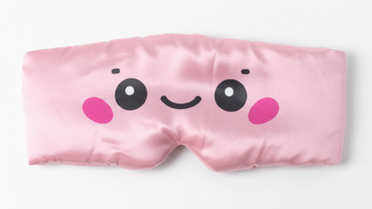 DI'AURA Pink sleep mask with a cute face design on a white background